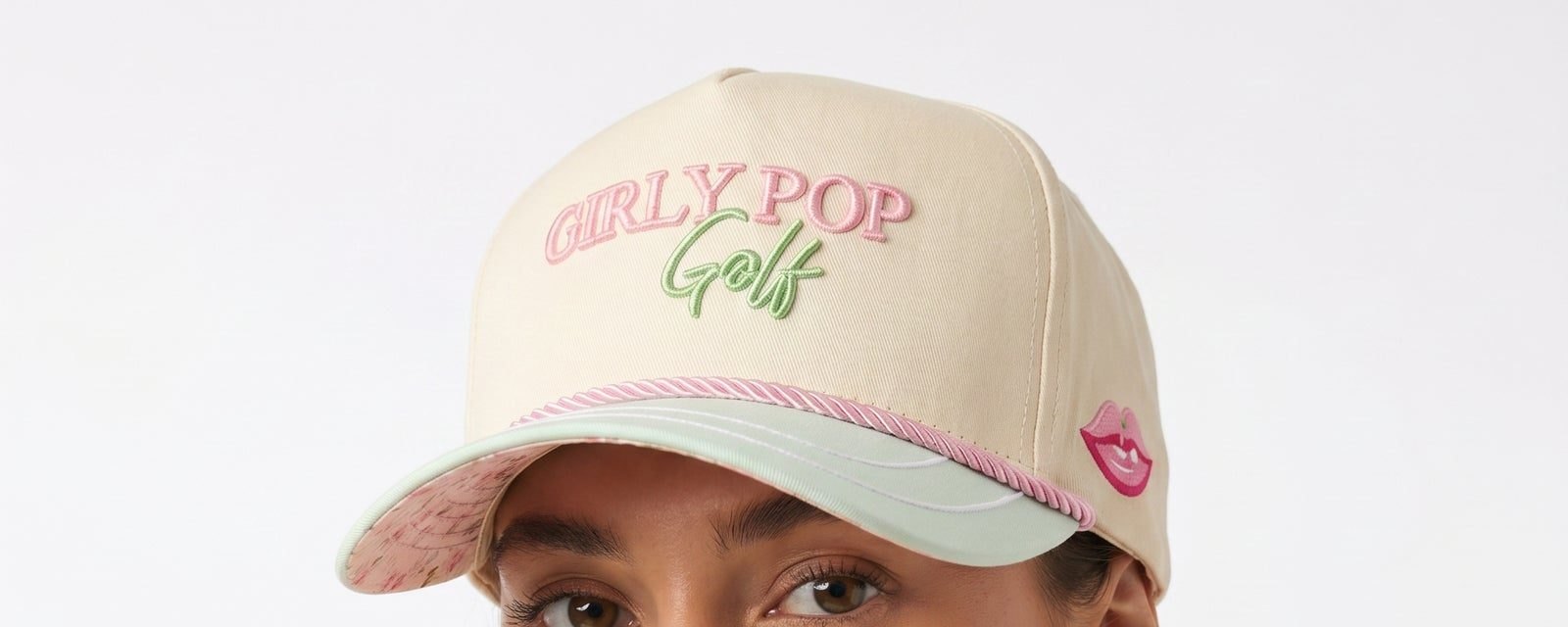 A member in a cream Girly Pop Golf cap with a mint brim, photographed close up.