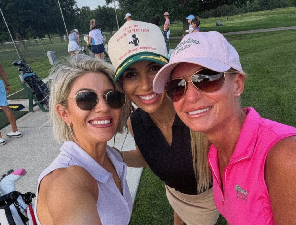Three members in caps and sunglasses beside the carts.